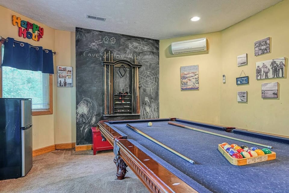 Gameroom view from couch.   Pool table and chalk board to keep score.