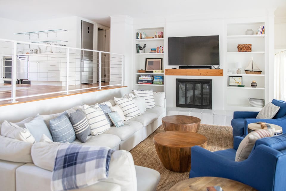 Family room with giant accordion sliders invites nature sounds and ocean breeze.