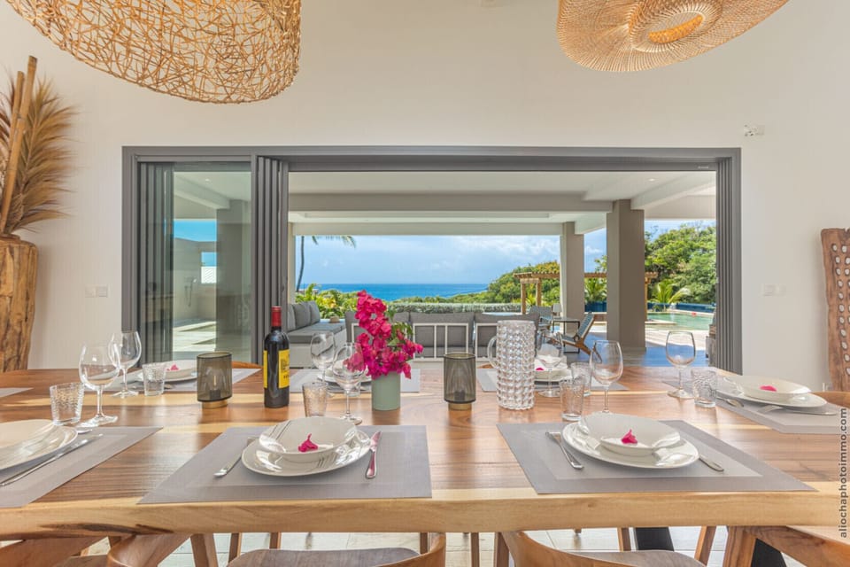 Share your meals at this magnificent solid wood table with panoramic ocean views.