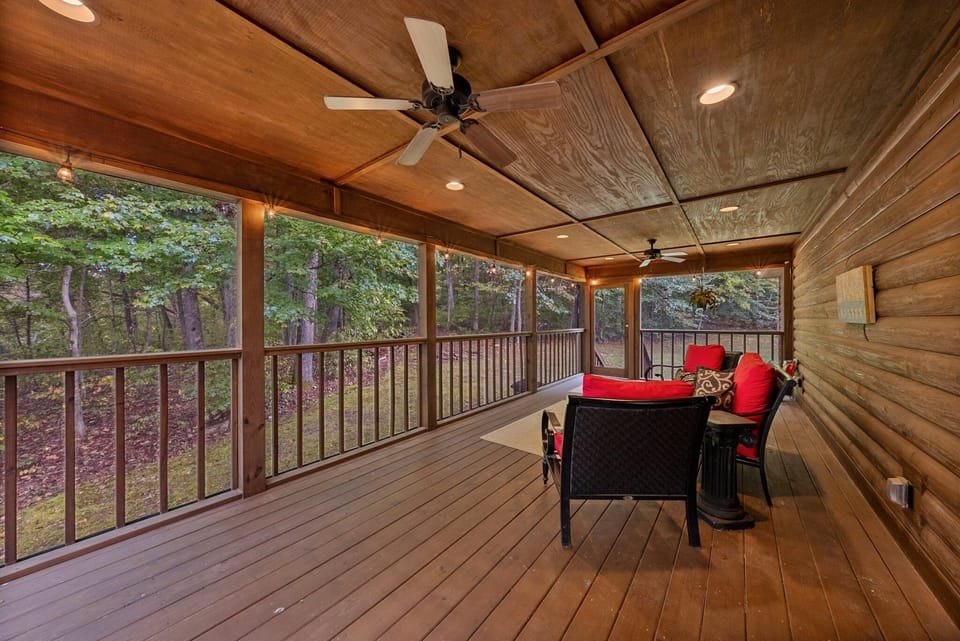 Relax on this spacious screened in porch overlooking the firepit area and woods.