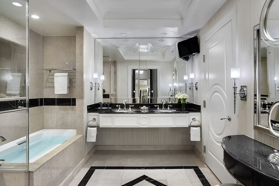 Refresh in a gleaming marble bath with double vanity.