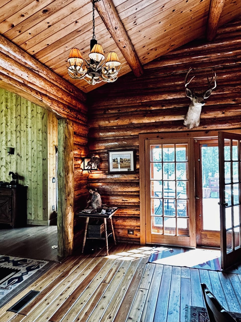 Family room with french doors to rear patio & propane fire table