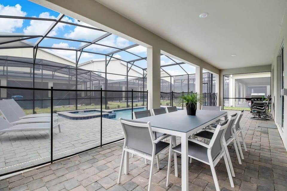 Relax and dine al fresco on this spacious patio with pool access, perfect for family gatherings or a quiet retreat.