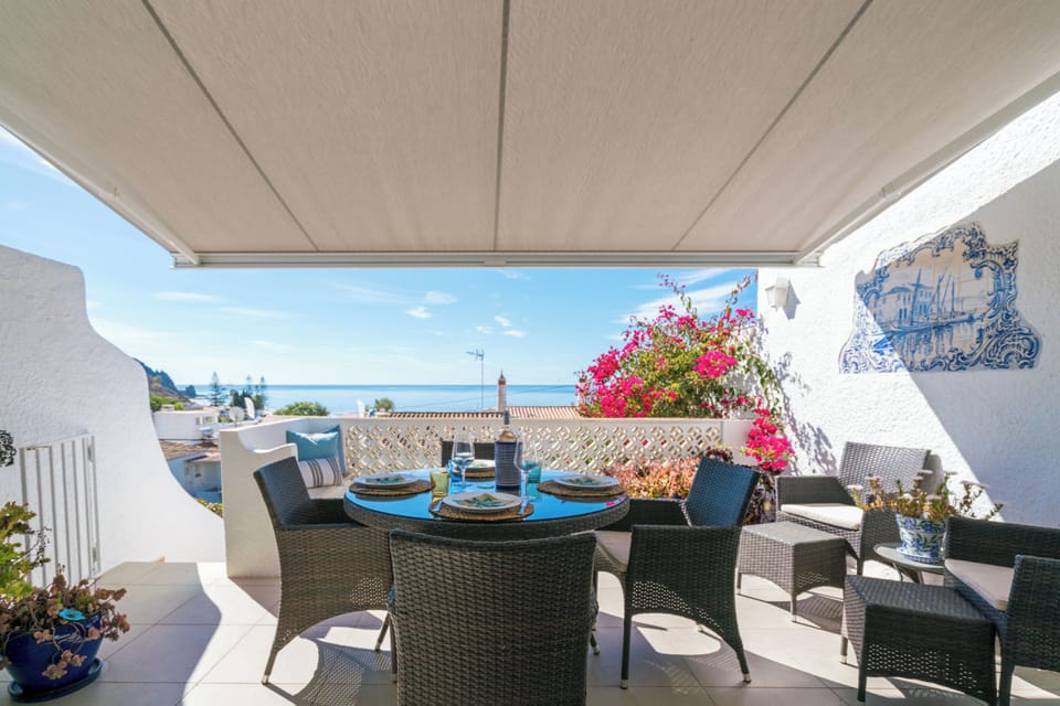 Large dining area on terrace with remote control sun shade