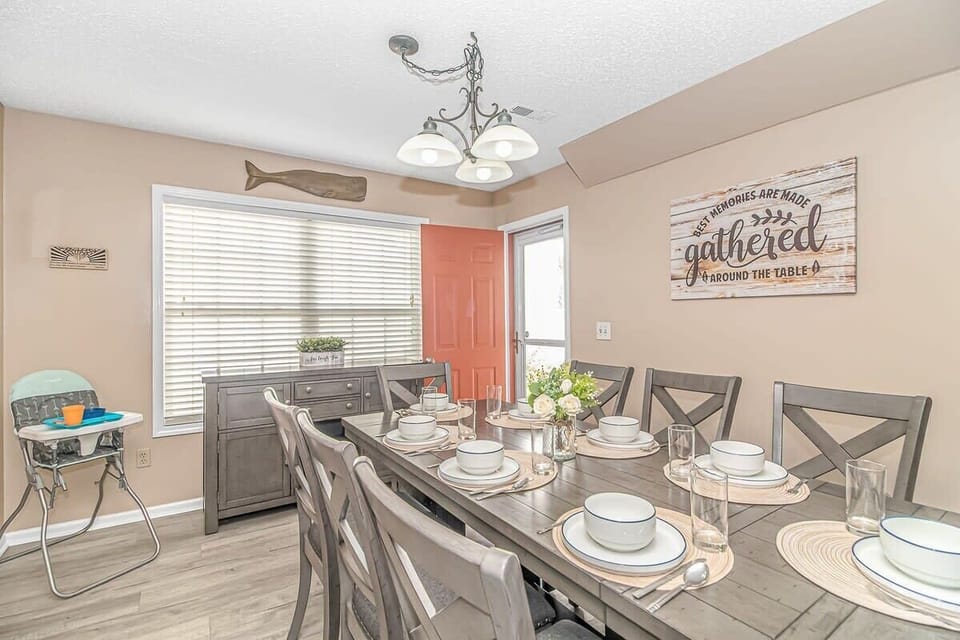 **Dining Room**: "Gather with family and friends for memorable meals in this inviting dining area, complete with ample seating and a charming ambiance perfect for any occasion."
