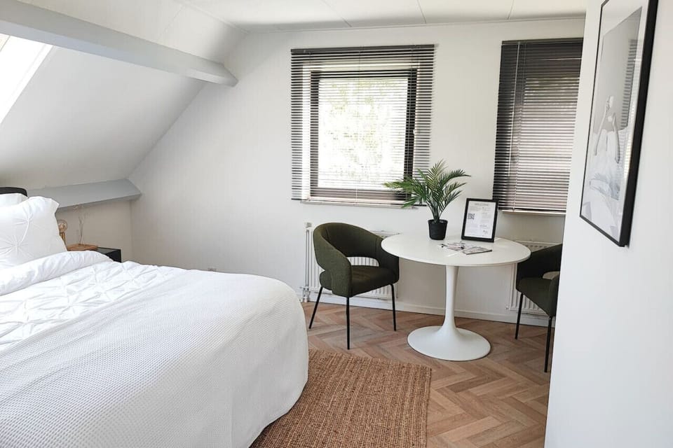 Room 1 has comfortable chairs and a table.