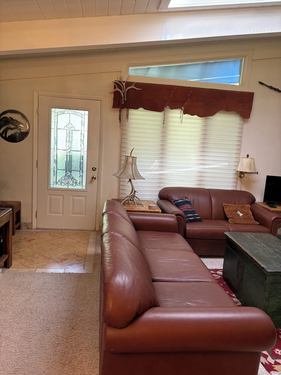 Entryway with coat closet and living room