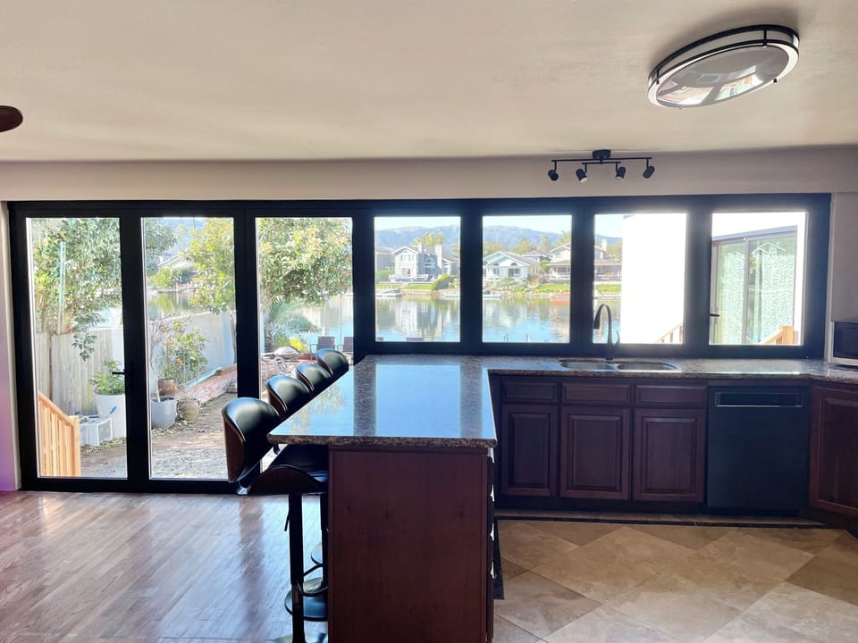 Kitchen - 4 barstools + 6 seats at the dining room table, luxury bifold doors