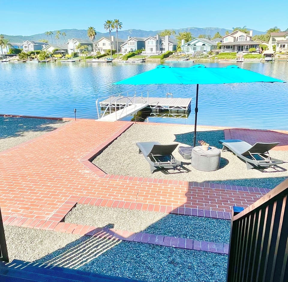Water access from Master bedroom, 2 lounge chairs with oversized umbrella