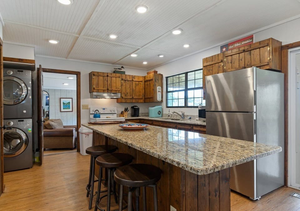Kitchen with island, fridge, dishwasher, stove, microwave