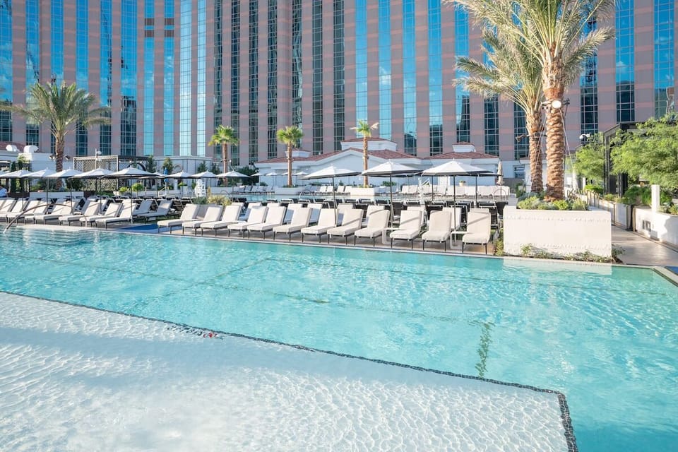 Dive into sparkling waters surrounded by chic daybeds.