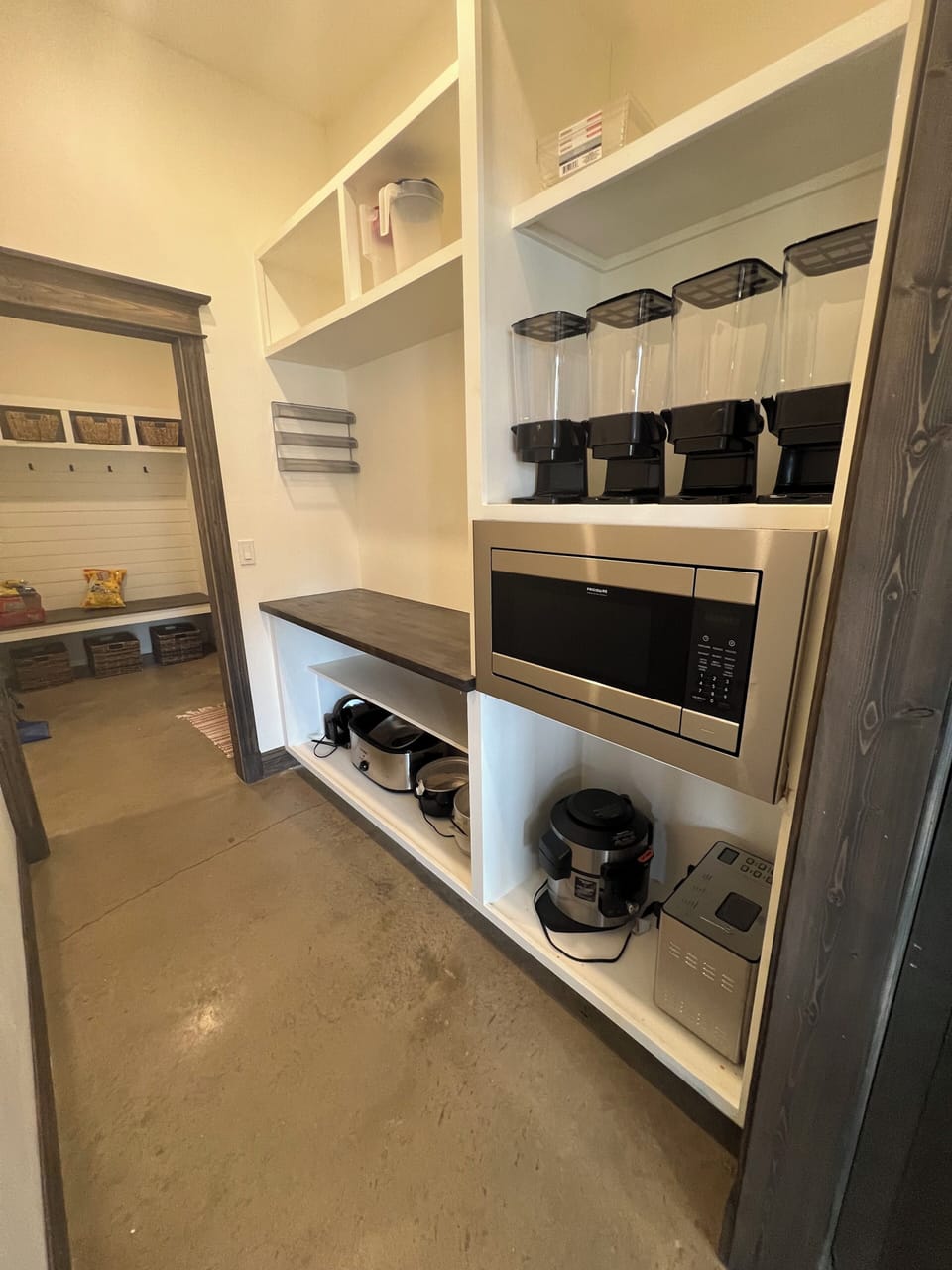 Enormous pantry with microwave, cereal dispensers, and small kitchen appliances