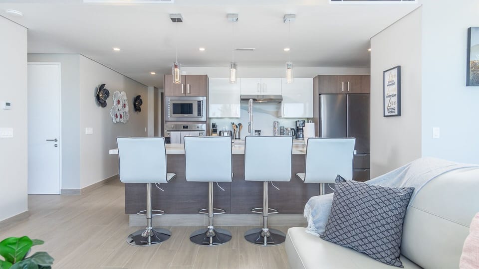 four bar stools line the kitchen island