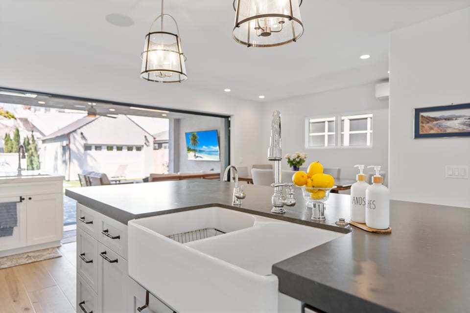 View from sink to dining room, patio, casita and backyard