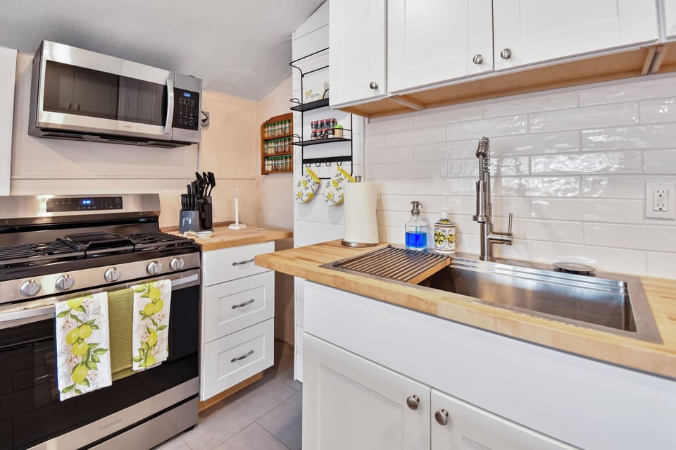 A newly remodeled and nice sized kitchen with butcher block countertops and center island