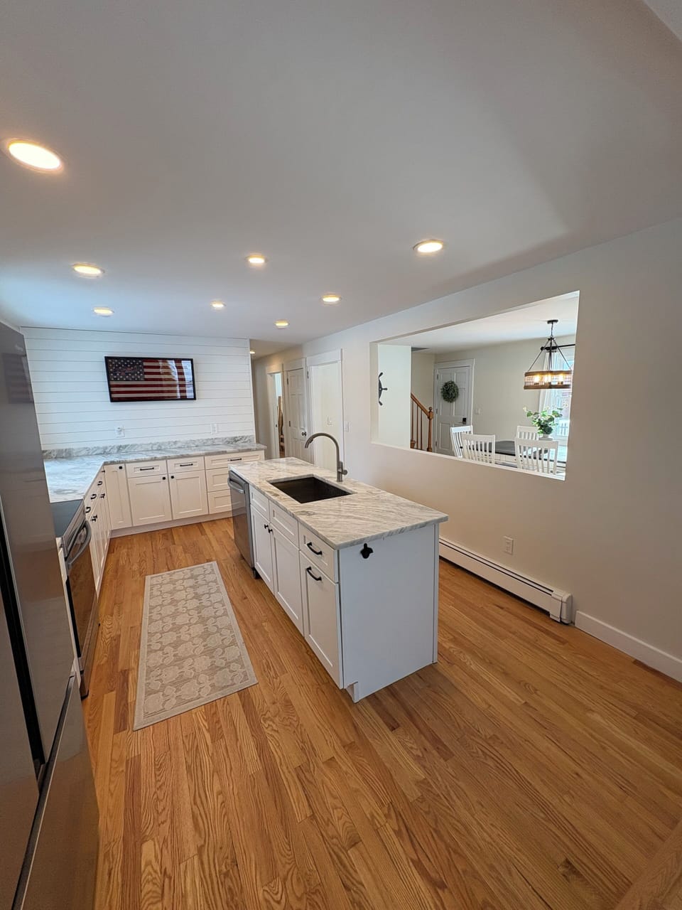 Fully equipped kitchen with stainless steel appliances and a DR look through