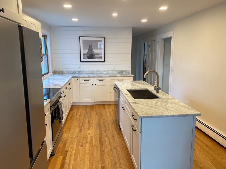 Fully equipped kitchen with stainless steel appliances and a DR look through
