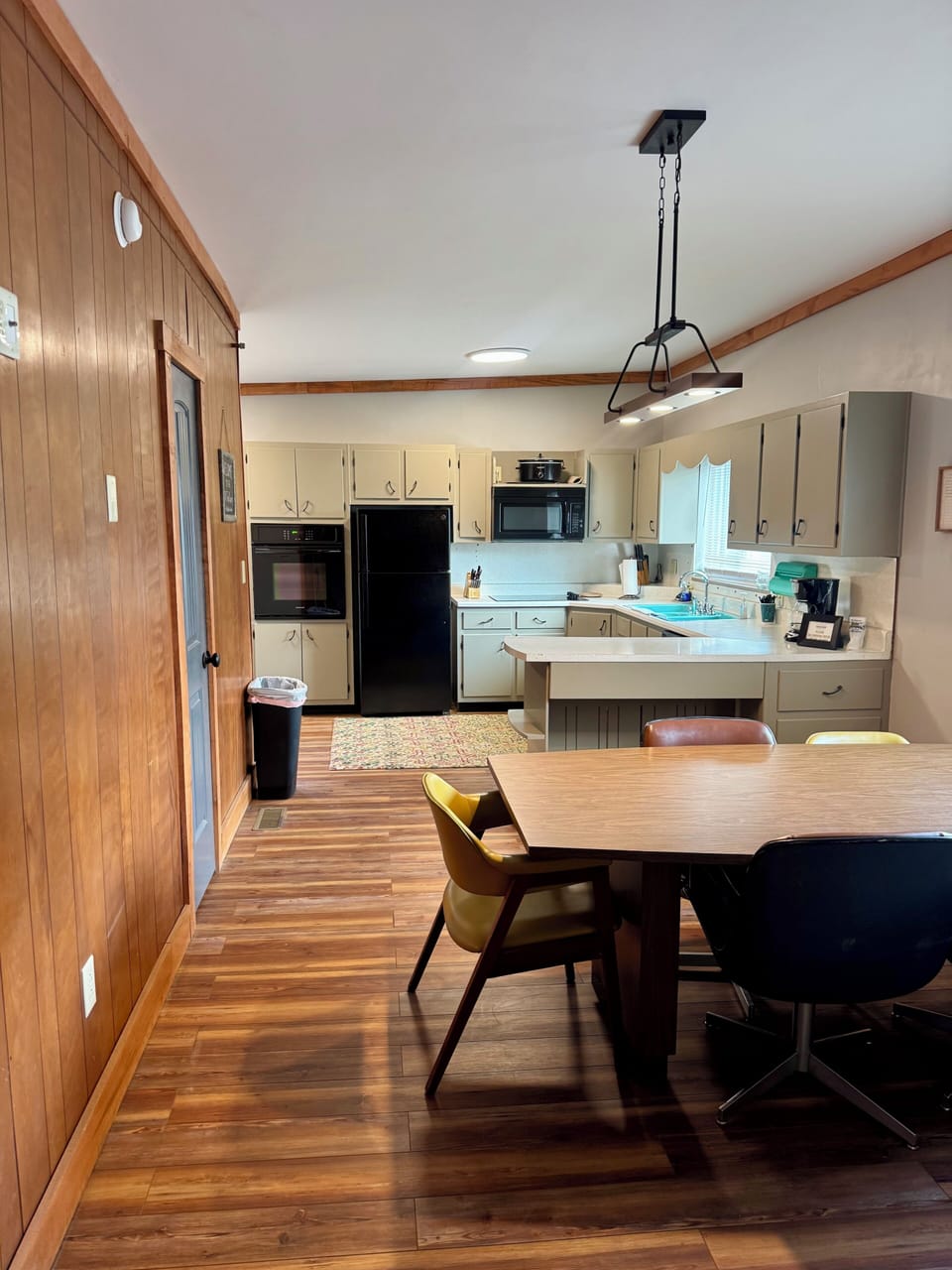 Full kitchen with dining table and chairs.