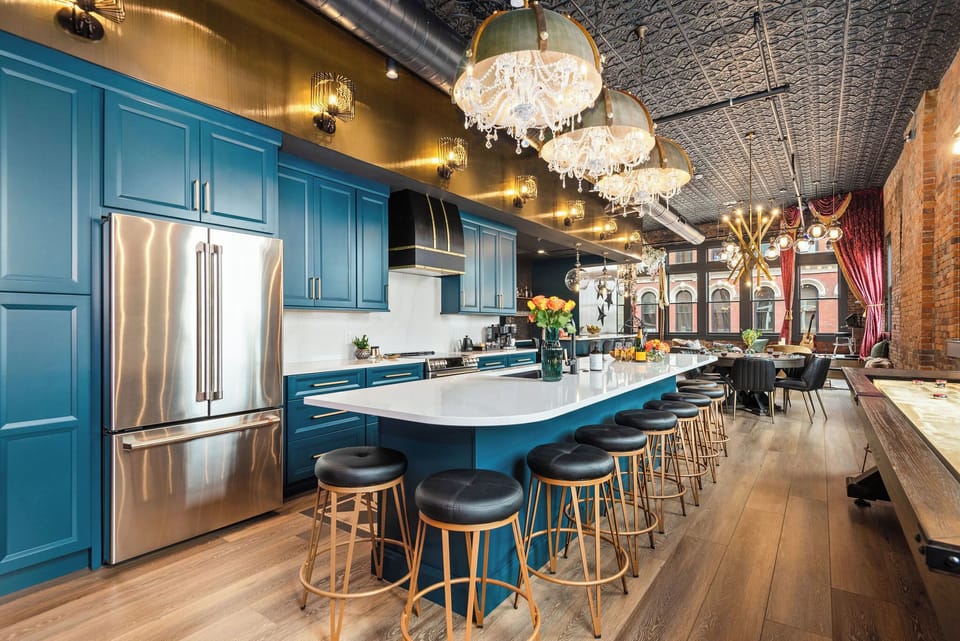 - Large kitchen island with multiple stools and chic chandeliers   - Stainless appliances, bright floors and modern lighting flow   - Ideal place for cooking, gathering and enjoying time together