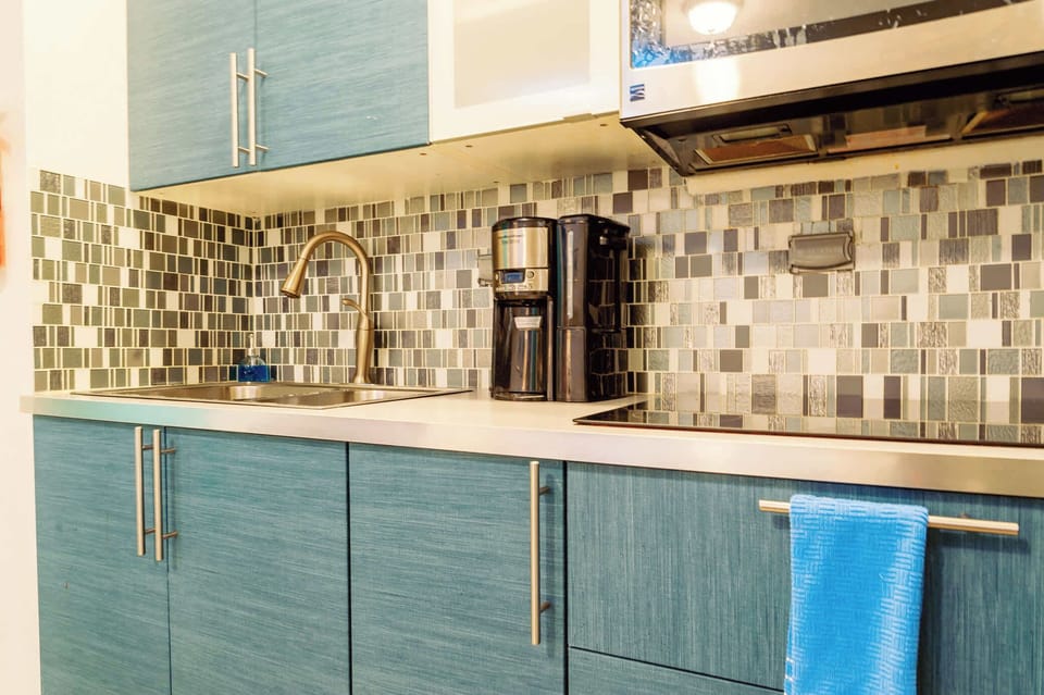 Well equipped kitchen featuring a coffee maker and a sink