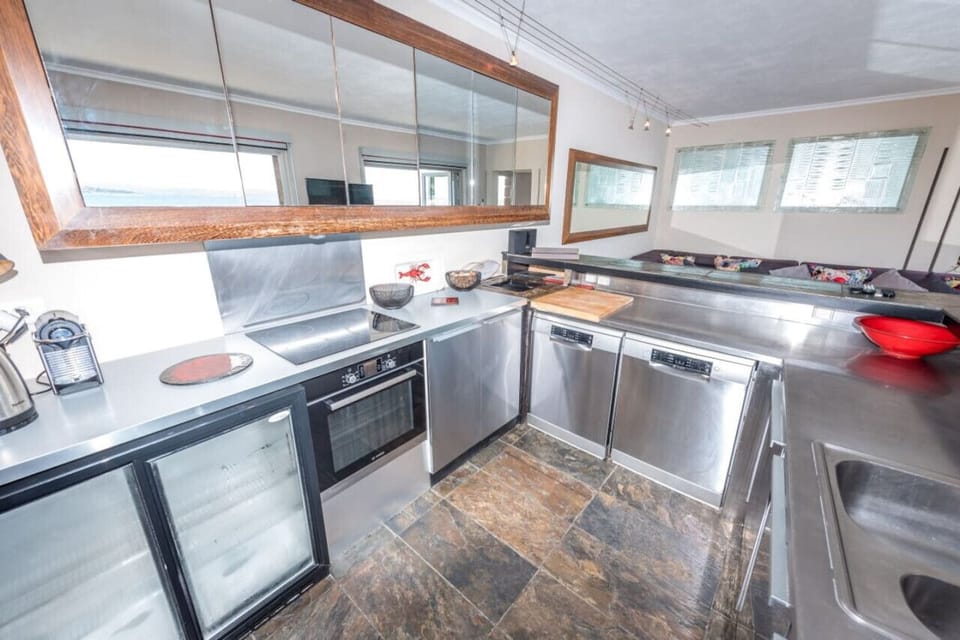 Modern kitchen with dual dishwashers and breakfast bar