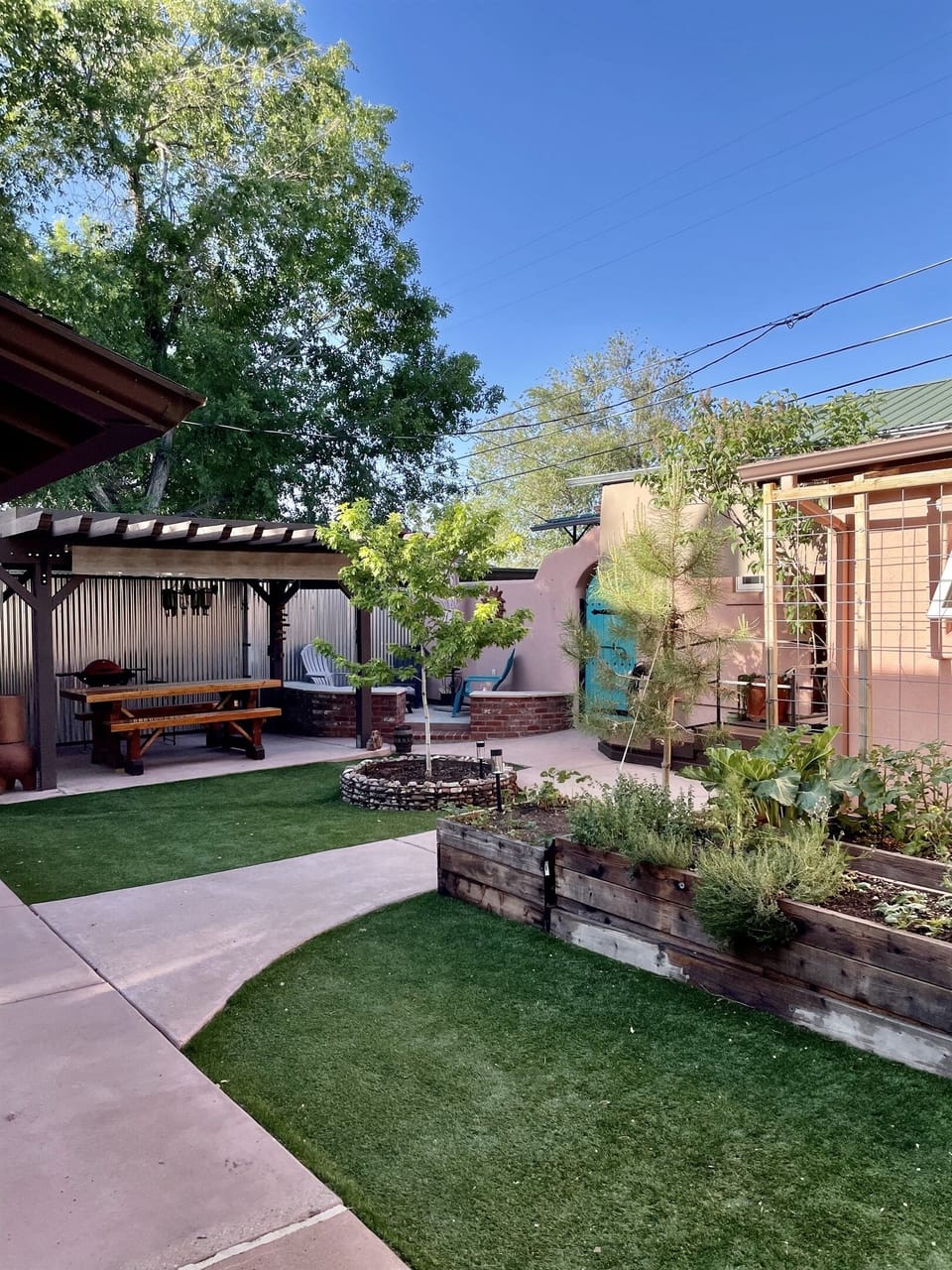 Escape to this tranquil courtyard oasis, complete with a picnic table, grill, fire pit, and lush greenery.