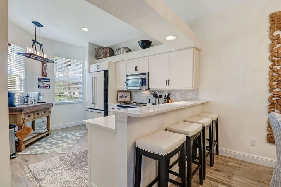 Light and sociable open plan kitchen area with breakfast bar and a comprehensive coffee bar!
