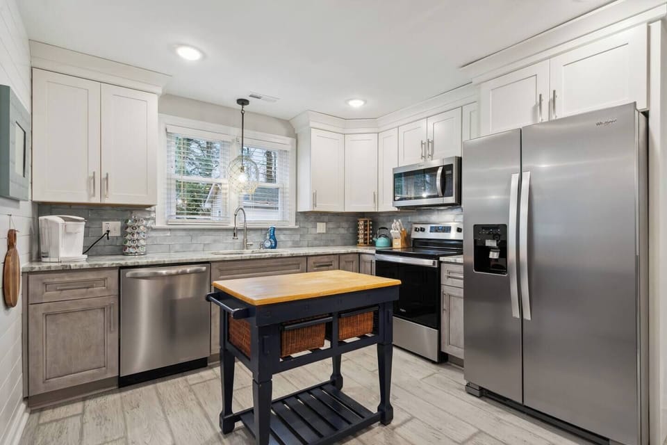 This well-equipped full kitchen provides everything you need to create delicious meals.  Top-of-the-line appliances, including a built-in oven, electric stove with burners, spacious refrigerator, and efficient dishwasher, offer functionality and power for all your culinary creations.  Ample drawers ensure all your cooking essentials are within reach, while a built-in microwave ...