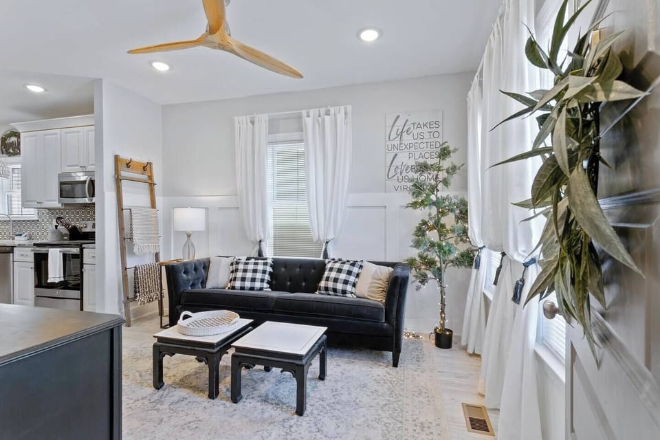 This captivating living room offers the perfect blend of comfort and style.  Relax and unwind on the plush couch, bathed in natural light from the beautiful windows. The dual coffee tables provide ample space for drinks, snacks, or displaying decorative items.  A modern ceiling fan keeps you cool and comfortable, while the smart TV ensures endless entertainment options.  This l...