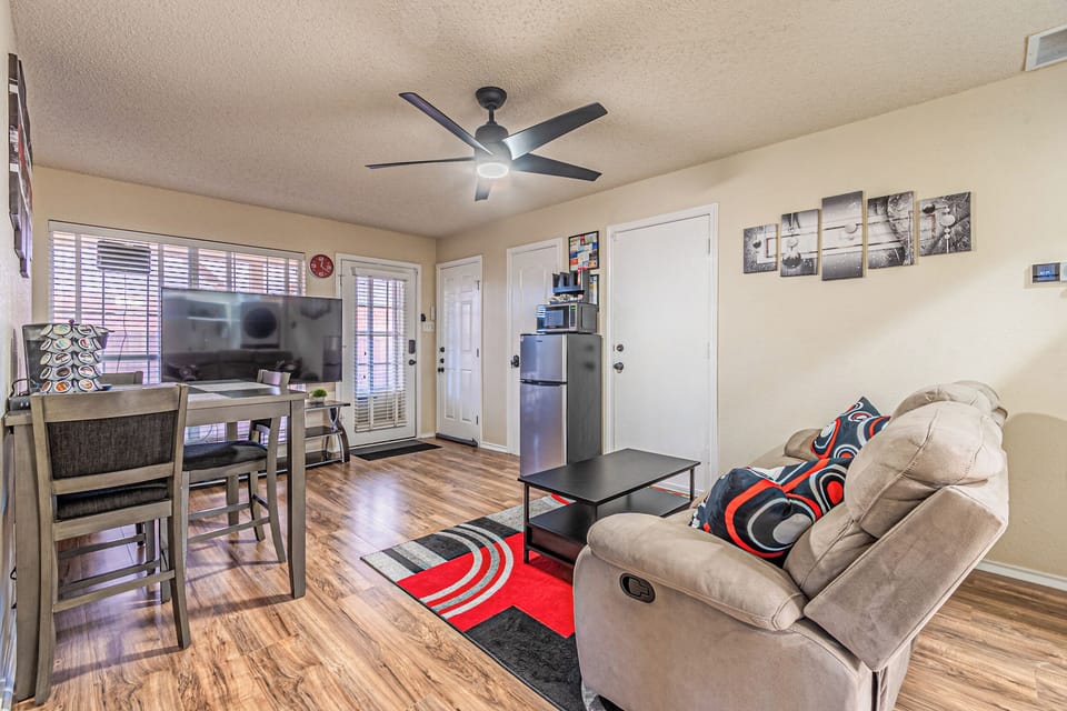 Lower-level living area with sofa, Smart TV, and workspace access