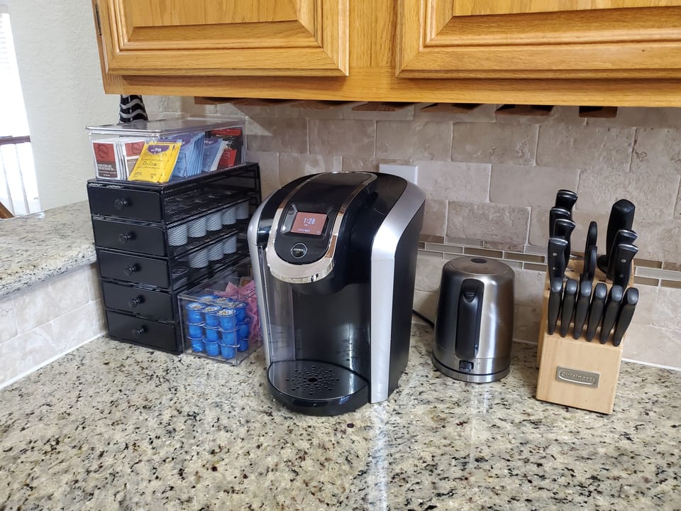 Coffee setup with Keurig, K-cups, tea, and everyday essentials.