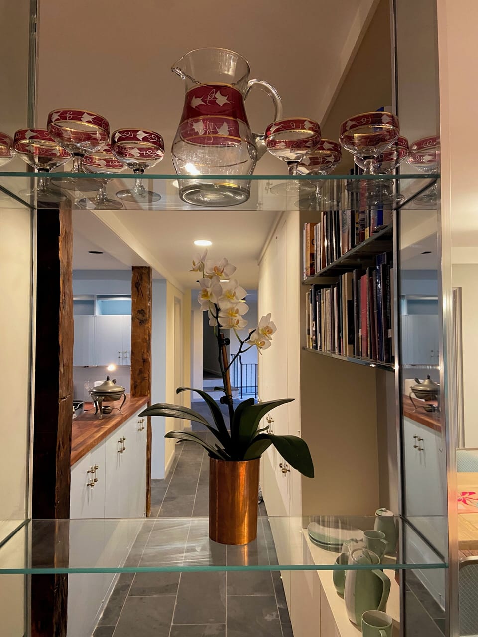 View from dining room through to front hall, with kitchen to the left