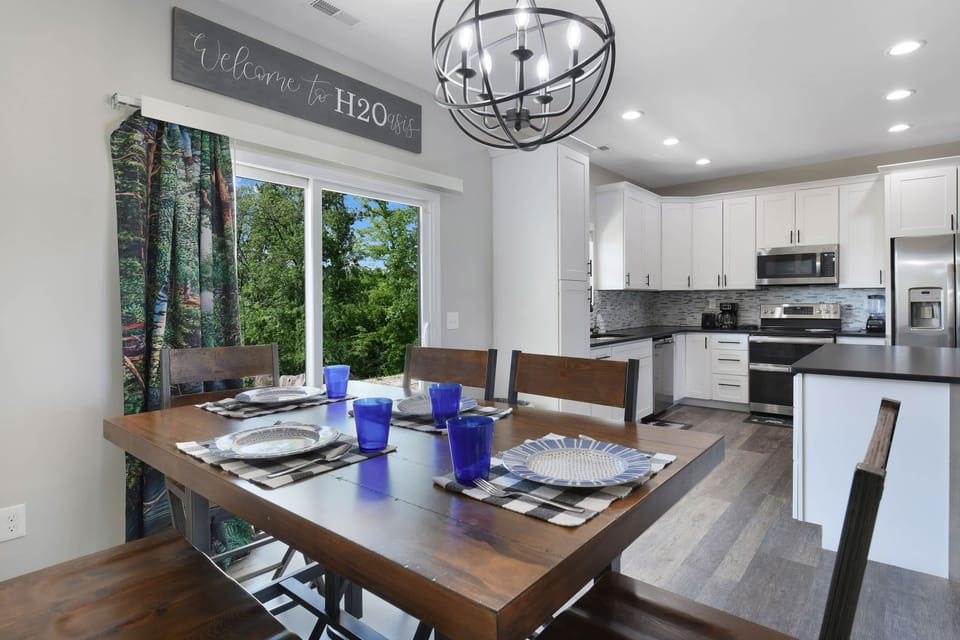 Modern kitchen and dining area with large sliding doors overlooking greenery