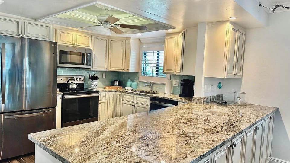 Fully-equipped kitchen; granite countertops.