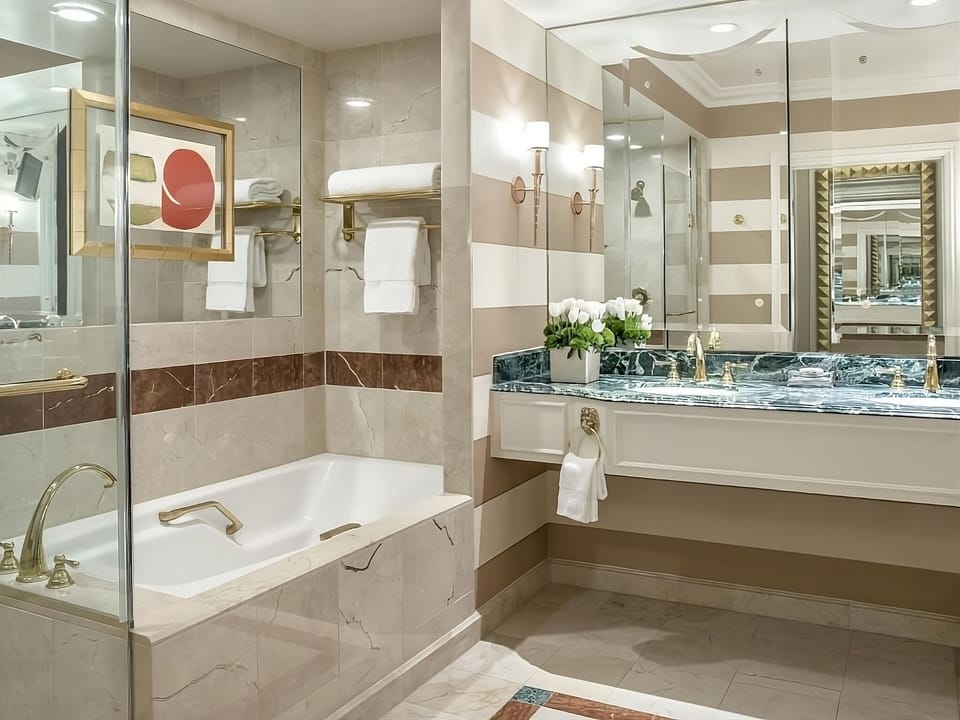 Refresh in a bright marble bath with oversized vanity space.