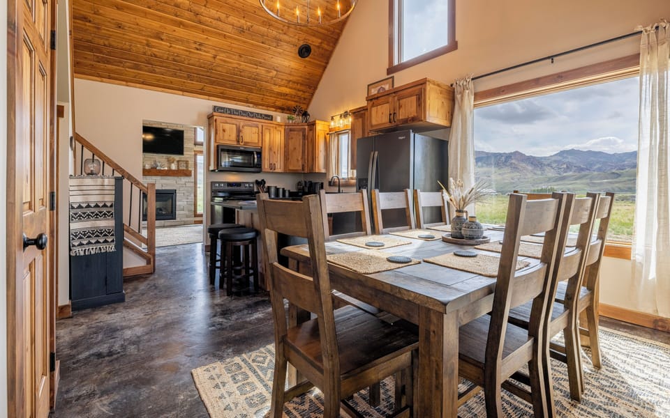 The open dining and kitchen greet you upon entry in to Lazy Bear Cabin.