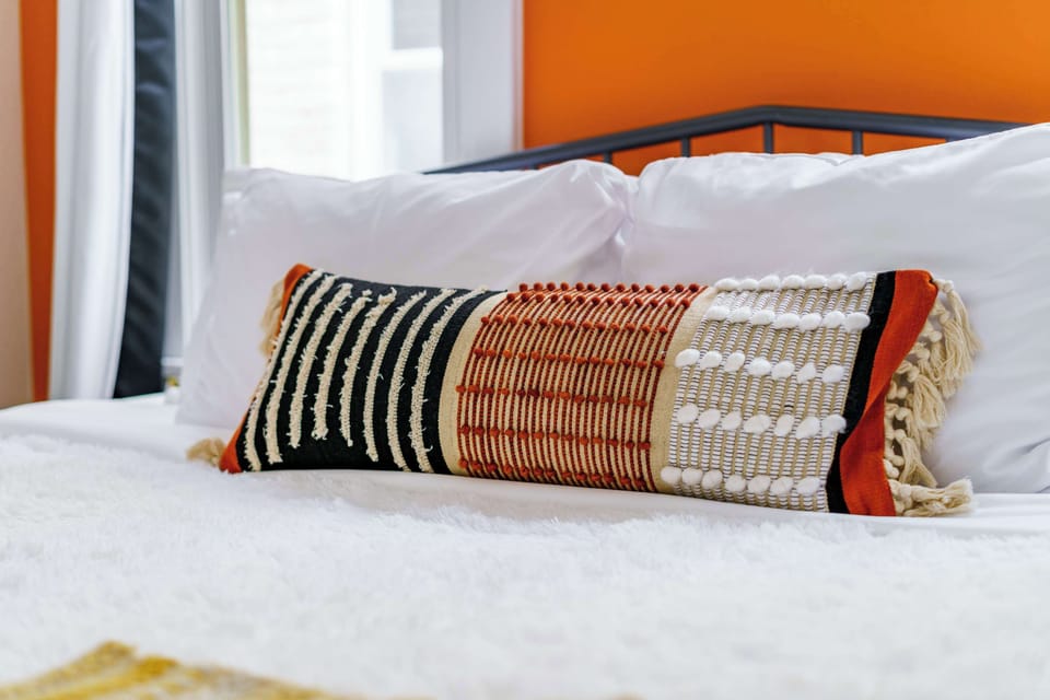 This chic bedroom features stylish decor and plush furnishings, located steps from the historical charm of German Village and downtown Columbus.