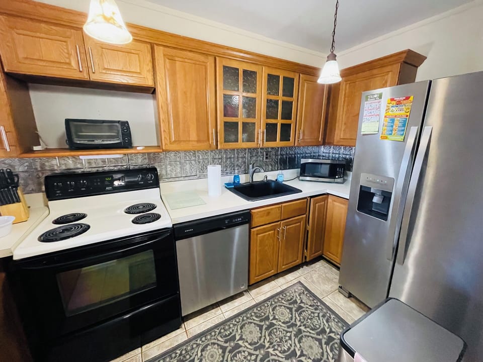 Step into a well-appointed kitchen designed for convenience. It includes a full-sized refrigerator, range, and plenty of counter space for meal prep. You'll find generous storage in the cabinetry, making it easy to keep things organized.
