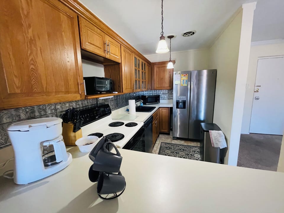 Step into a well-appointed kitchen designed for convenience. It includes a full-sized refrigerator, range, and plenty of counter space for meal prep. You'll find generous storage in the cabinetry, making it easy to keep things organized.