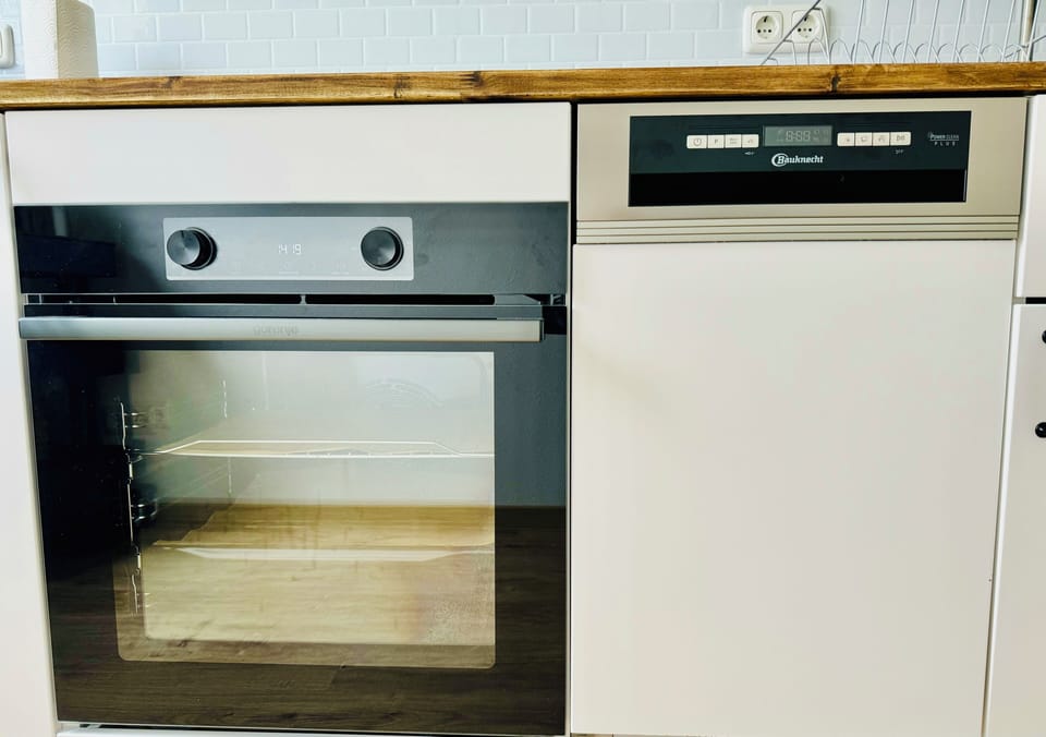 Kitchen includes an oven and dishwasher for easy cooking and cleanup