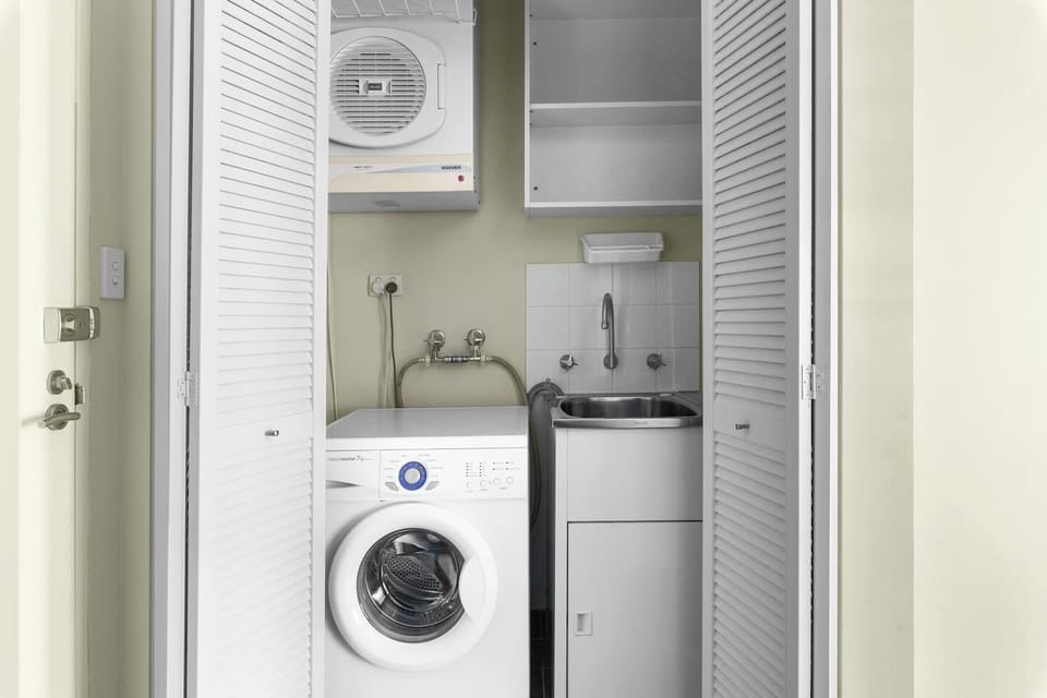 Enjoy the convenience of a laundry nook, neatly tucked away behind bifold shutter doors. There is a washing and drying machine and an additional sink and storage shelves. 
