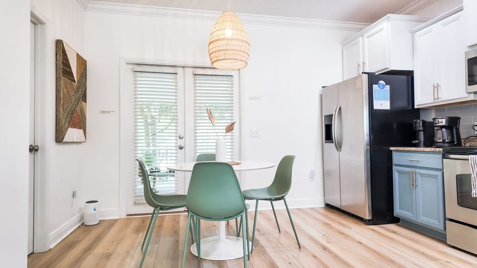 Eat-in kitchen located at back door to porch with pool view.