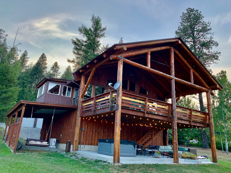 The Cabin at dusk, surrounded by peaceful forestry and an alpenglow. 