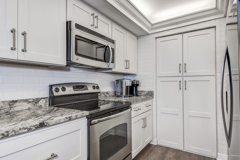 Pantry holds extra kitchen gadgets with room for groceries.