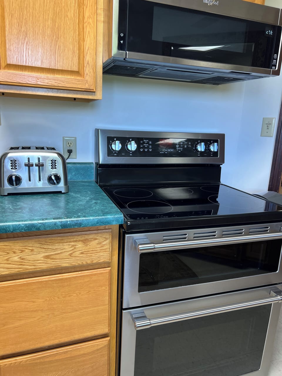 Stove with double ovens and full size microwave above.