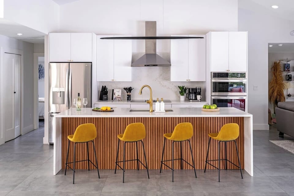 Fully stocked contemporary kitchen with a six-burner electric cooktop.
Pull up to the island to chat, sip, or snack while cooking—it’s where meals and memories happen!
