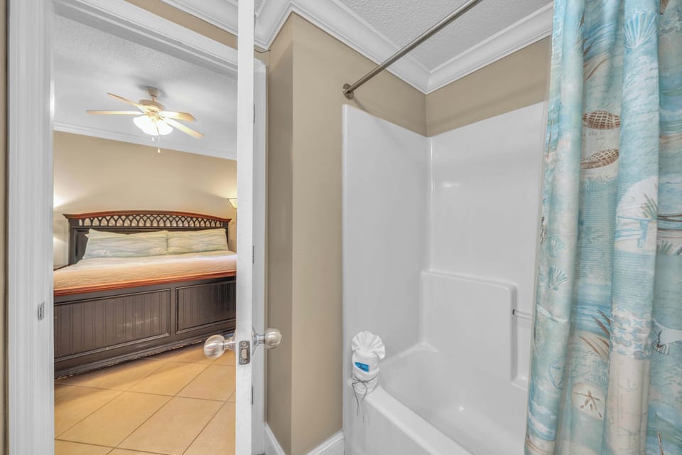 The master bedroom offers a King size bed, television, and ensuite bathroom with tub/shower combo.