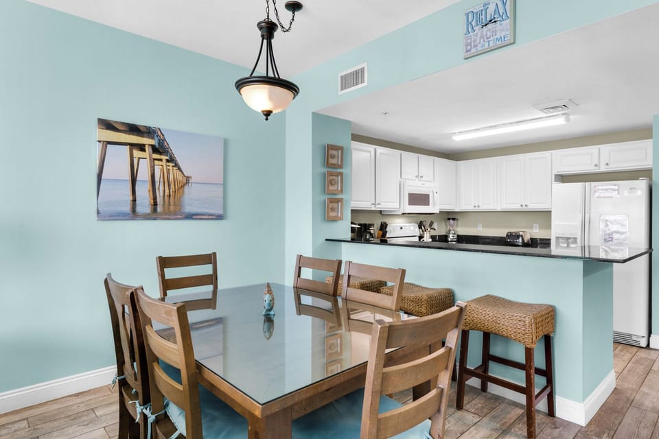 Dining Area - A bright, stylish dining area for six ideal for enjoying fresh meals and good conversation with the beach as your dining companion. Includes 3 bar stools for extra seating.