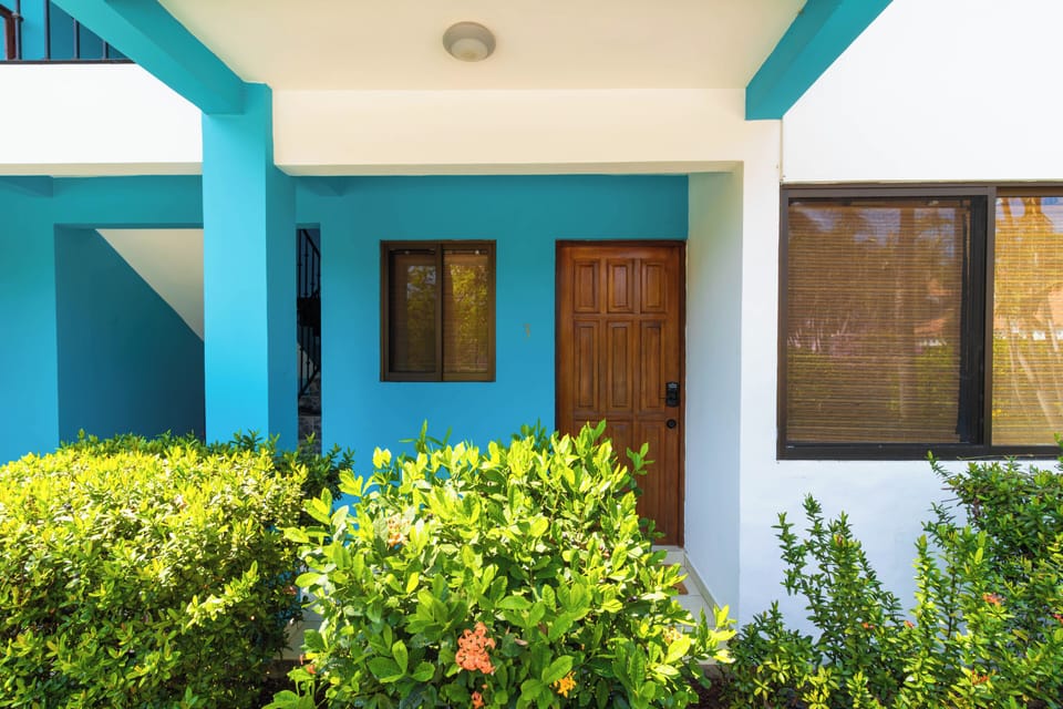 Solid wooden front door welcomes guests to the cozy coastal condo.
