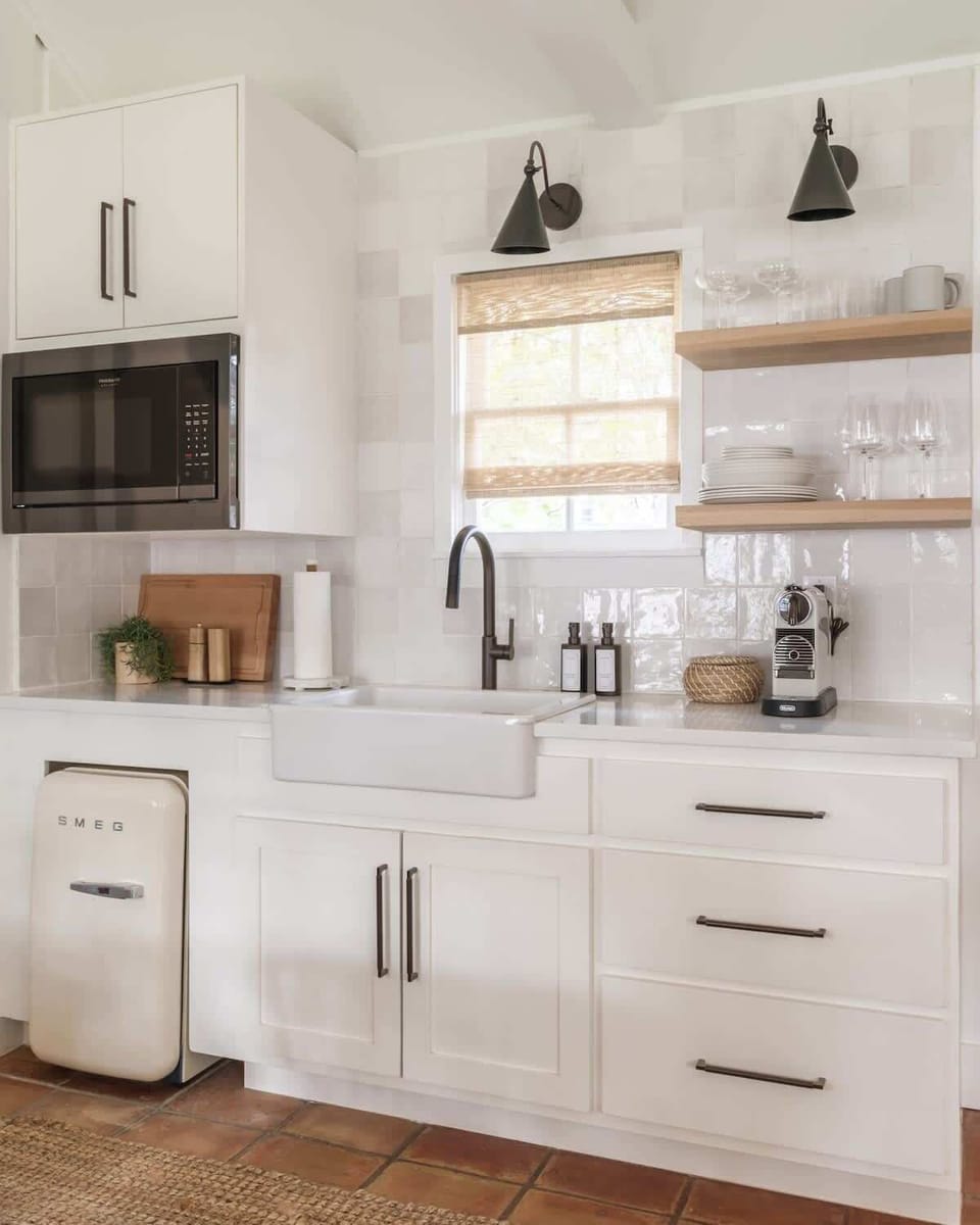 Stocked kitchenette with microwave, mini fridge and tableware